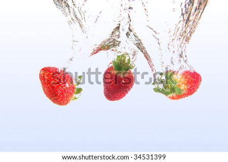 healthy strawberry fruits splashing in cool water