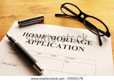 home mortage application form on desktop in office showing real estate concept
