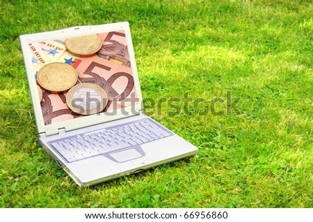 laptop and money showing electronic business or ecommerce concept
