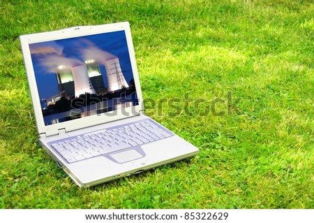 power plant in laptop or notebook screen showing energy supply concept