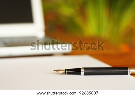 business desktop still life with folder pen copyspace and laptop in office