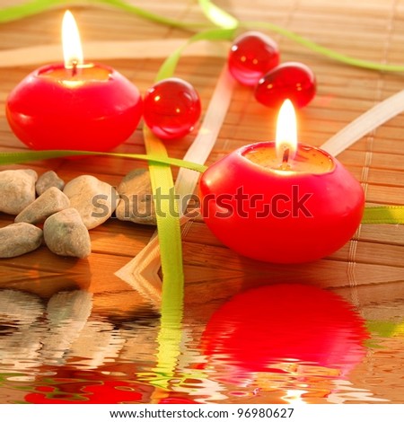 spa candle and water reflection showing zen concept