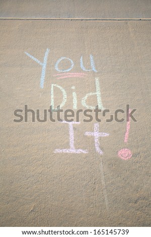 You did it, a message written in chalk on the sidewalk.