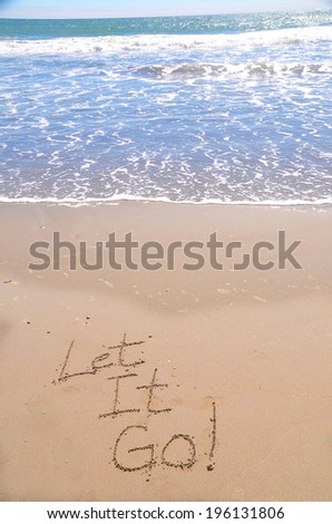 Let it go, a message written in sand at the beach.