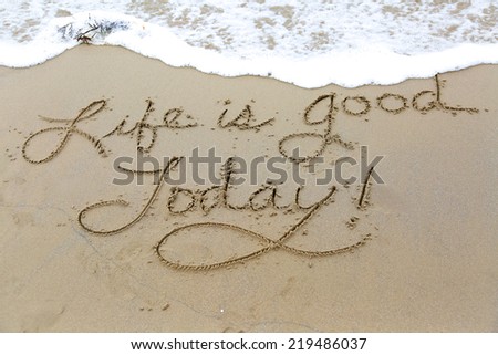 Life is good today, a message written in the sand at the beach.
