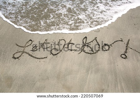 Let it go, a message written in sand at the beach