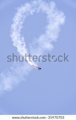 DENVER, COLORADO - AUGUST 22: A stunt plane performs a full loop leaving a circle of smoke at the Jefferson County Airport air show August 22, 2009 in Denver Colorado.