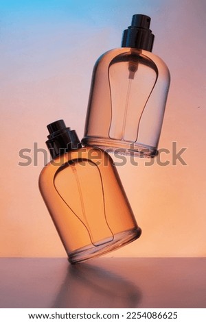 Levitation of set of perfume bottles on a gradient background
