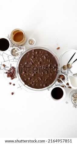 trifle with biscuit, caramel, nuts, cream and chocolate in glass round deko, ingredients on table, dessert or sweets for holiday, white background, top view, flat lay with copy space Stock foto © 