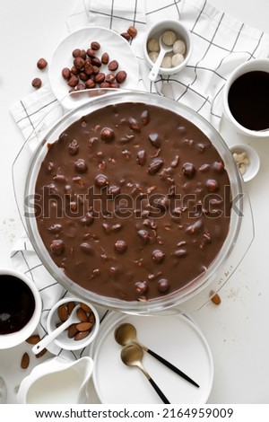 trifle with biscuit, caramel, nuts, cream and chocolate in glass round deko, ingredients on table, dessert or sweets for holiday, white background, top view, close up, flat lay Stock foto © 