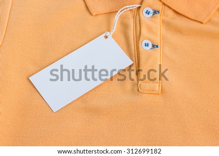 Close - up Blank tag label on orange shirt