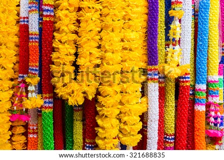 background of colorful plastic garlands for worship