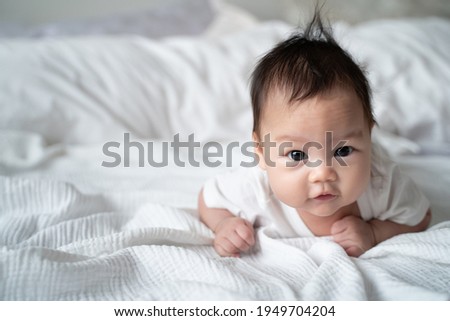 Similar – Image, Stock Photo 3 month old baby doing tummy time; bohemian interior room with houseplants