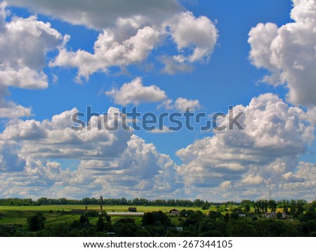 Cumulus clouds cascade in the form of a tick on a bright blue sky