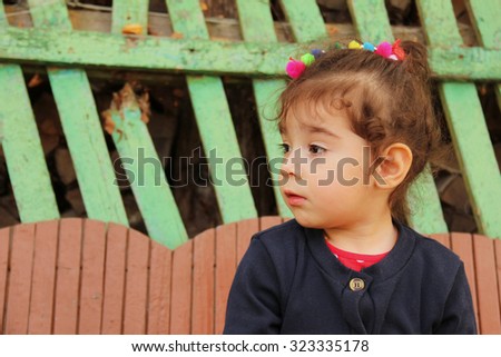 Profile of little girl with sad face looking away
