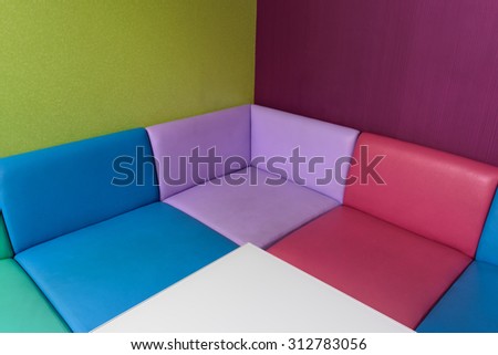 Colorful sofa and white table in colorful room