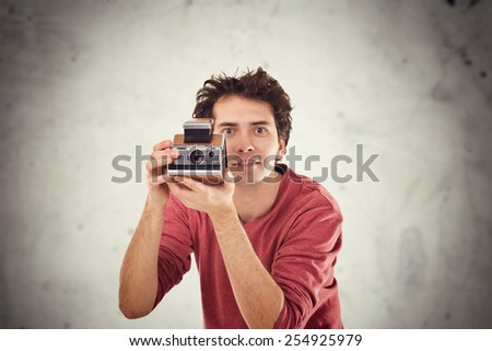 Young Man With Instant Vintage Camera.