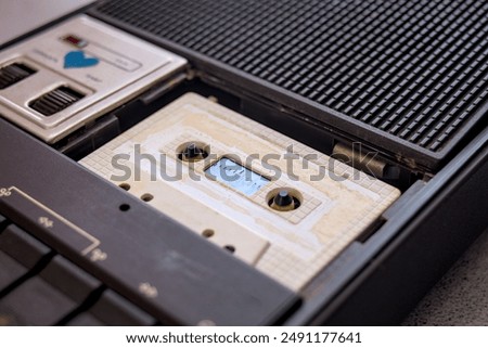 Image, Stock Photo Compact cassette tapes and cassette recorder. Retro music style. 80s music party. Vintage style. Analog equipment. Stereo sound. Back to the past