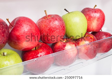 Fresh and clean apples on the refrigerator shelf. good to eat in diet.