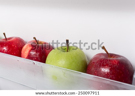 Fresh and clean apples on the refrigerator shelf. good to eat in diet.