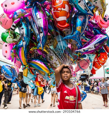 Thailand June 27: Boy sell cartoon balloon  in Phitakhon festival  on june 27 ,2015 in loei province of thailand
