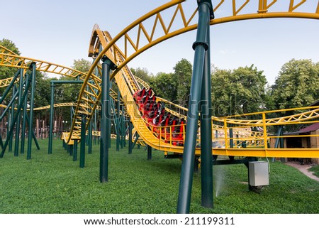 Coaster with people screaming in a kids park