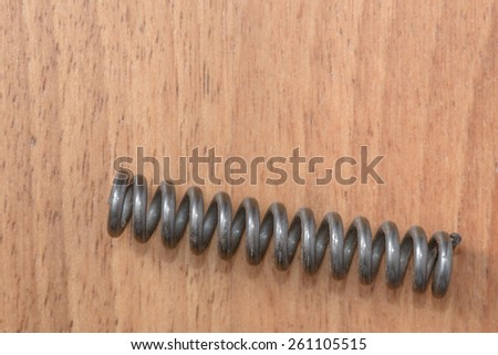 One steel spring on the wood