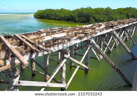 Decommissioned wooden bridge from mainland to Boca Paila Peninsula, spans the outlet of the lagoon to the Caribbean Sea, Puente de Boca Paila, Q.R., Mexico - September 2020:  Photo stock © 