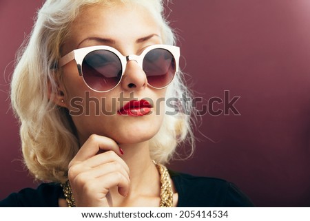 Portrait of beautiful young woman looking right wearing sunglasses