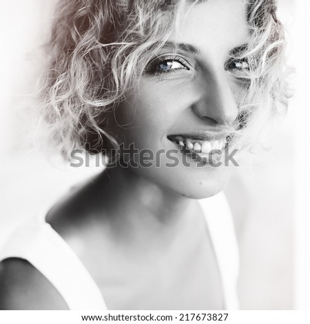 Young happy laughing girl on the street. Black and white portrait