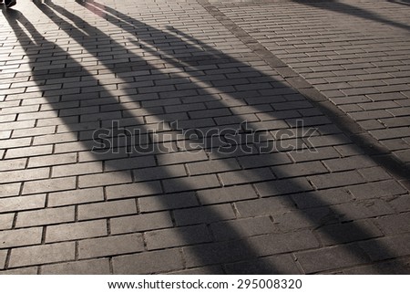 human shadows on pavement