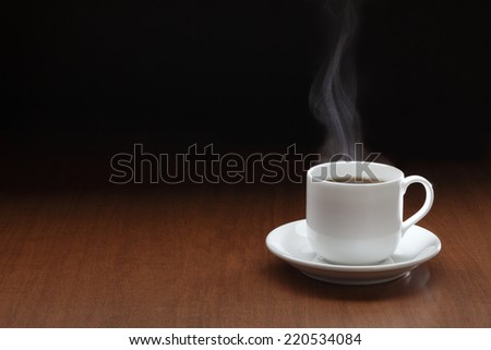 Cup of black coffee/Cup of black coffee with steam on the wooden table
