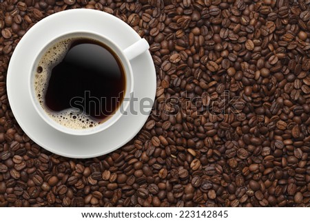 Cup of coffee on beans