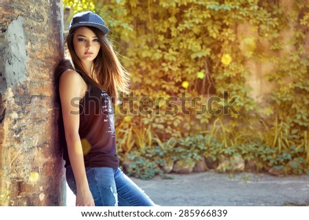 street fashion portrait of young beautiful woman in trendy casual wear.