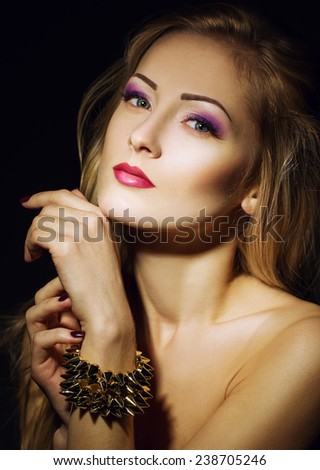 beautiful girl with perfect skin, blond hair and blue eyes posing on the black background. Close up portrait. interesting make up with purple color. Girl like rose concept