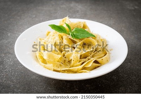 Image, Stock Photo Green tagliatelle pasta with ham, parmesan cheese, arugula and tomatoes on black plate