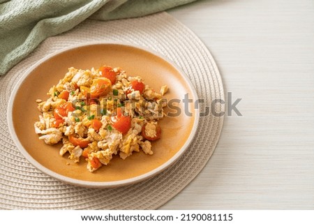 Similar – Image, Stock Photo Fried eggs with tomatoes and broccoli in white frying pan on kitchen table with ingredients. Top view. Healthy breakfast