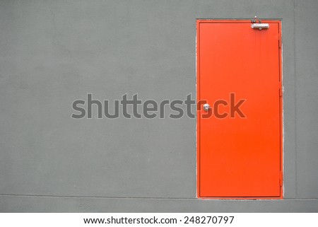 orange door on grey wall