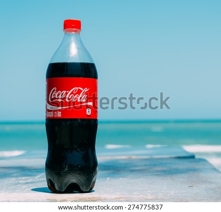 Pranburi,Thailand. March 31,2015.Coca cola bottle with sea background. Coca-Cola is a carbonated soft drink sold in stores, restaurants