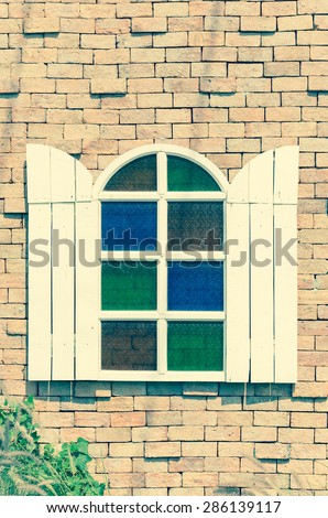 white vintage window on brick wall - soft focus with vintage filter