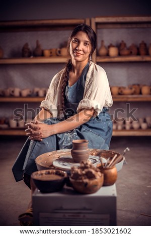 Pottery master demonstrates a finished clay bowl in the workshop  . Making pottery. Stock fotó © 