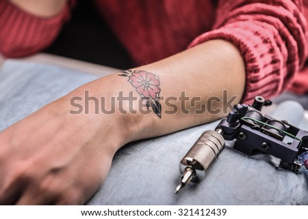 Tattoo Machine and Hand after Work