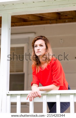 Beautiful young woman leaning on rail white verandah