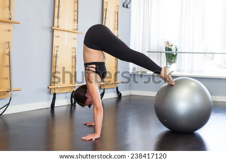 Beautiful woman doing pike up with stability ball