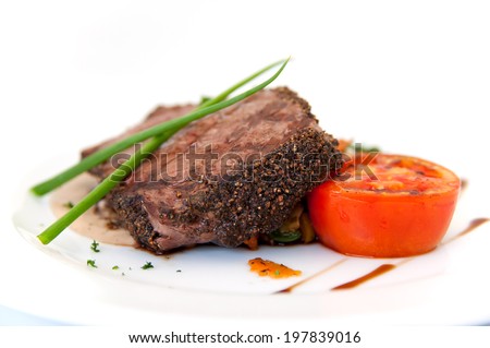 Pepper steak with tomato on white background