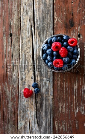 Top view of Fresh Berries on Rustic Wooden Background. Summer or Spring Organic Berry over Wood. Agriculture, Gardening, Harvest Concept