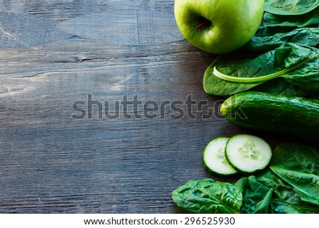 Fresh green vegetables on dark wooden background with space for text. Detox, diet or healthy food concept.