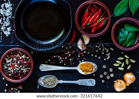 Food background with cuisine ingredients on dark vintage texture. Spices and herbs selection. Top view. Colorful natural additives.