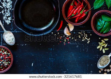 Cuisine ingredients on dark vintage texture. Spices and herbs selection. Top view. Background with space for text.