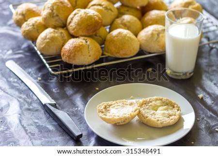 baked bread and buns with a glass of milk. can be used for baker, bread, breakfast, flour, food, dairy themes